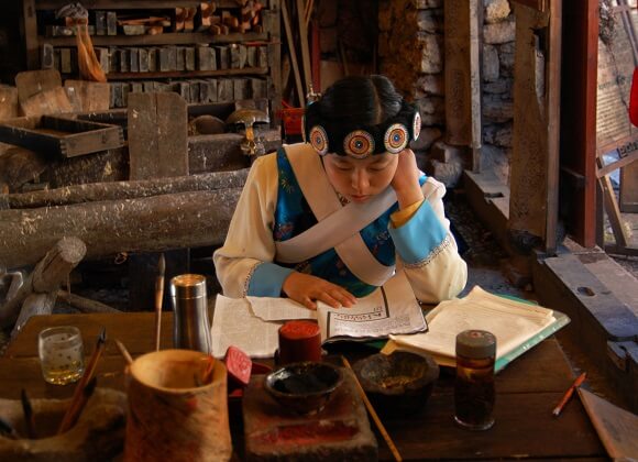 Naxi girl reading a book