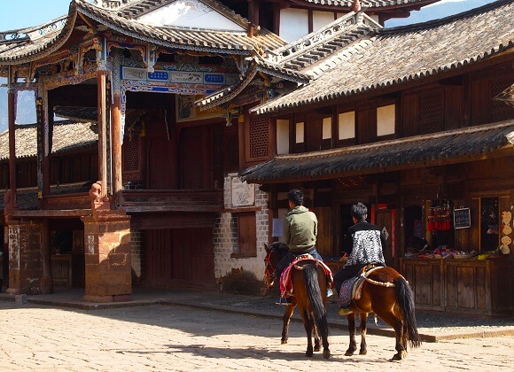 People riding horses in Shaxi